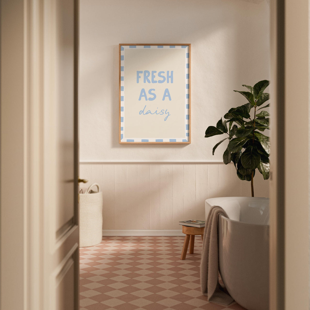 Bathroom interior with a framed quote on the wall, plant, and bathtub.