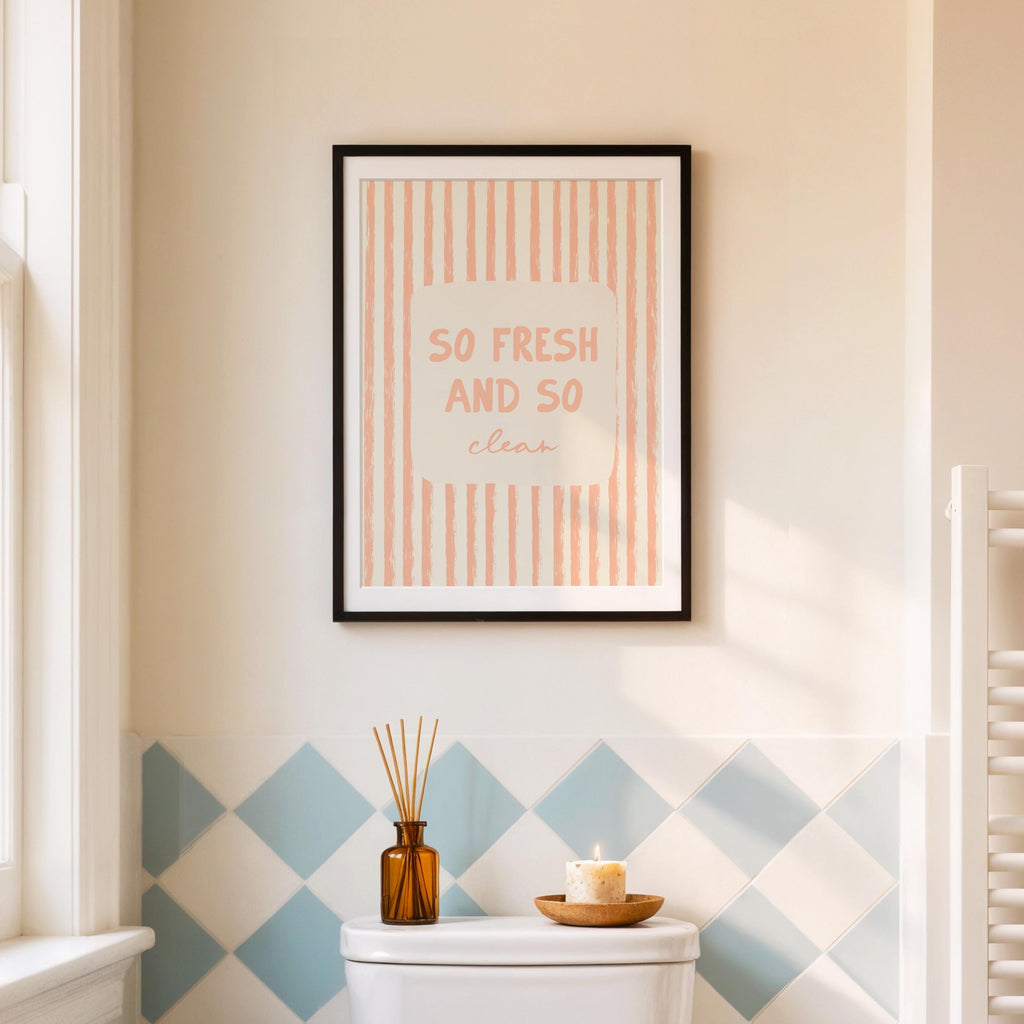 Framed poster with 'So Fresh and So Clean' text on a wall with geometric tile pattern.