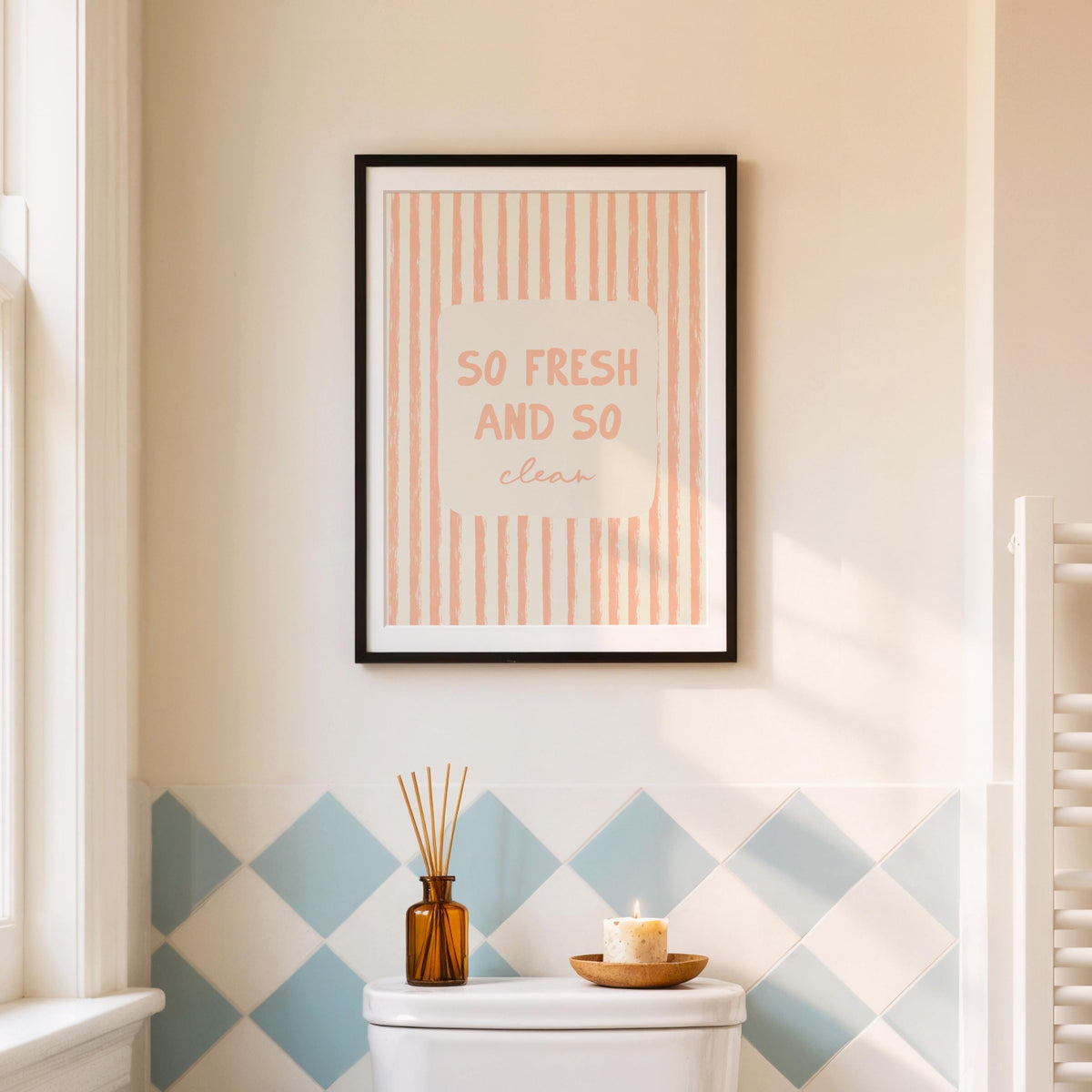 Framed poster with 'So Fresh and So Clean' text on a wall with geometric tile pattern.