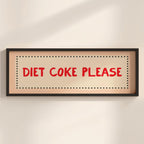 Framed sign with 'Diet Coke Please' text on a beige wall