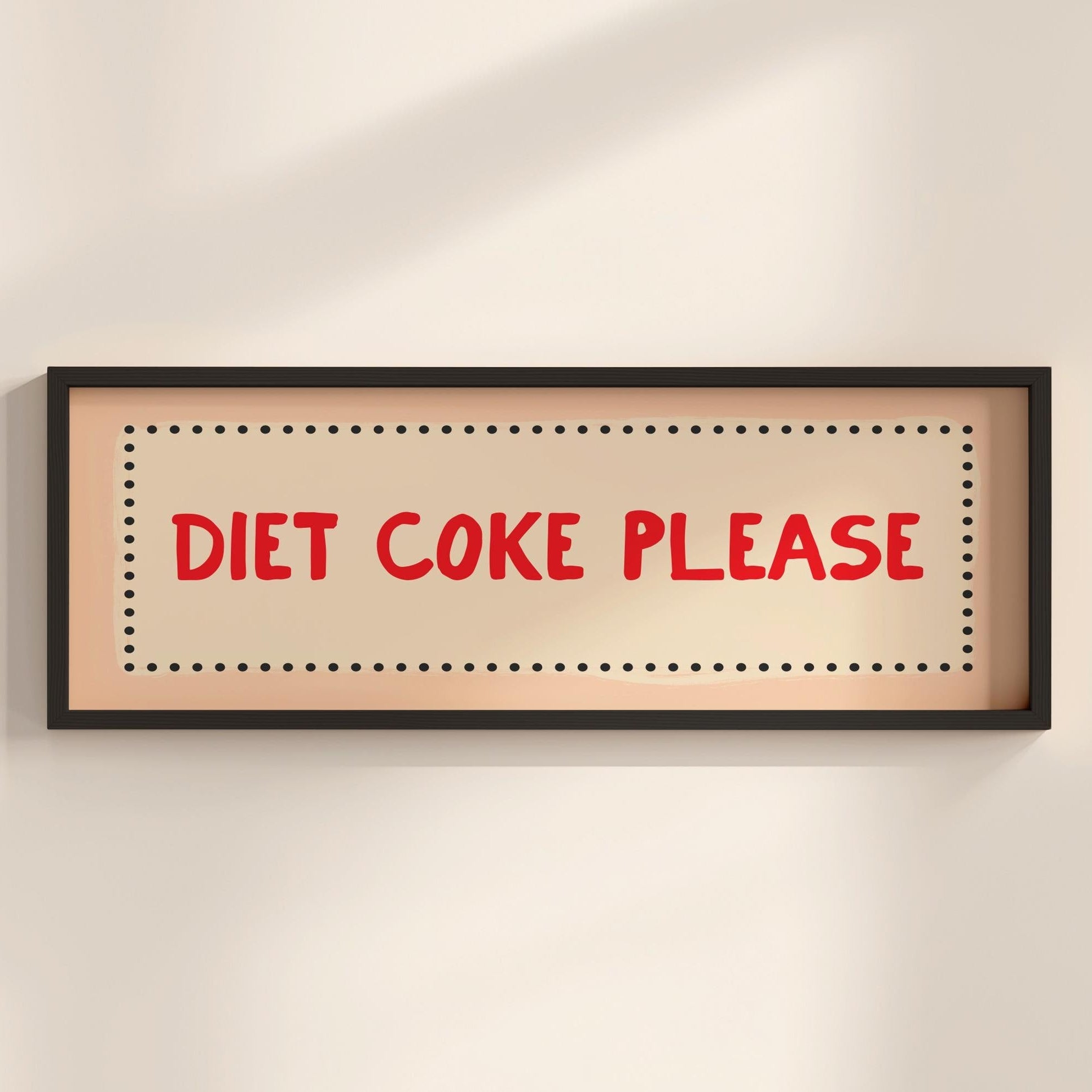 Framed sign with 'Diet Coke Please' text on a beige wall