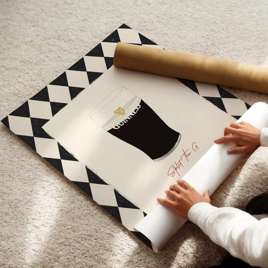 Person unrolling a large poster with a brand logo on a patterned mat.