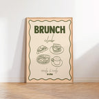 Framed poster with 'Brunch Club' text and food illustrations on a white wall.