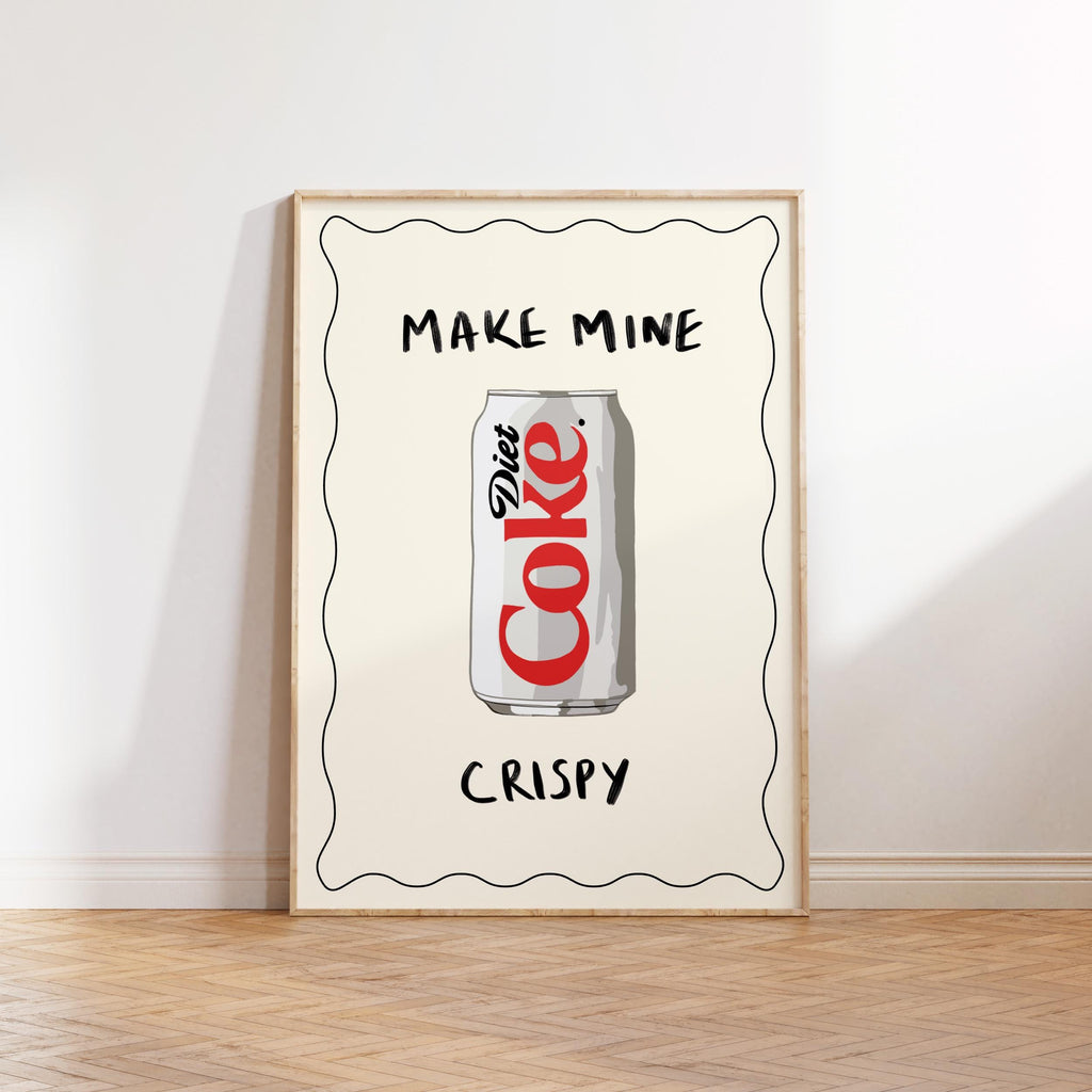 Framed artwork with a can of Diet Coke and text 'Make mine Diet Coke, crispy' on a white wall.
