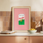 Framed artwork of a Perello can on a kitchen counter with a tiled wall background