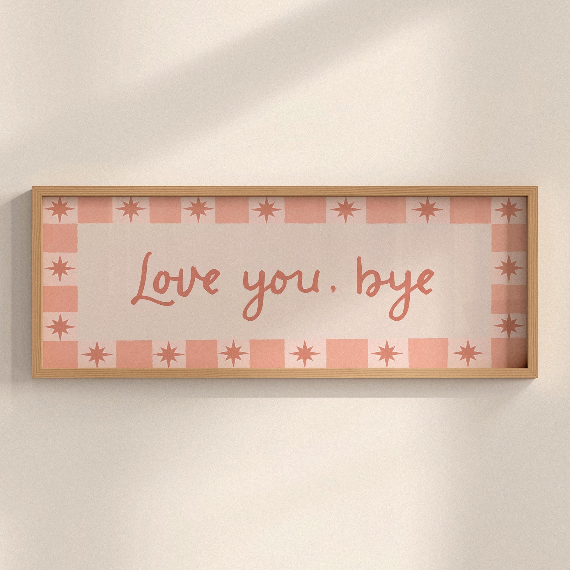 Framed artwork with 'Love you, bye' text on a checkered background