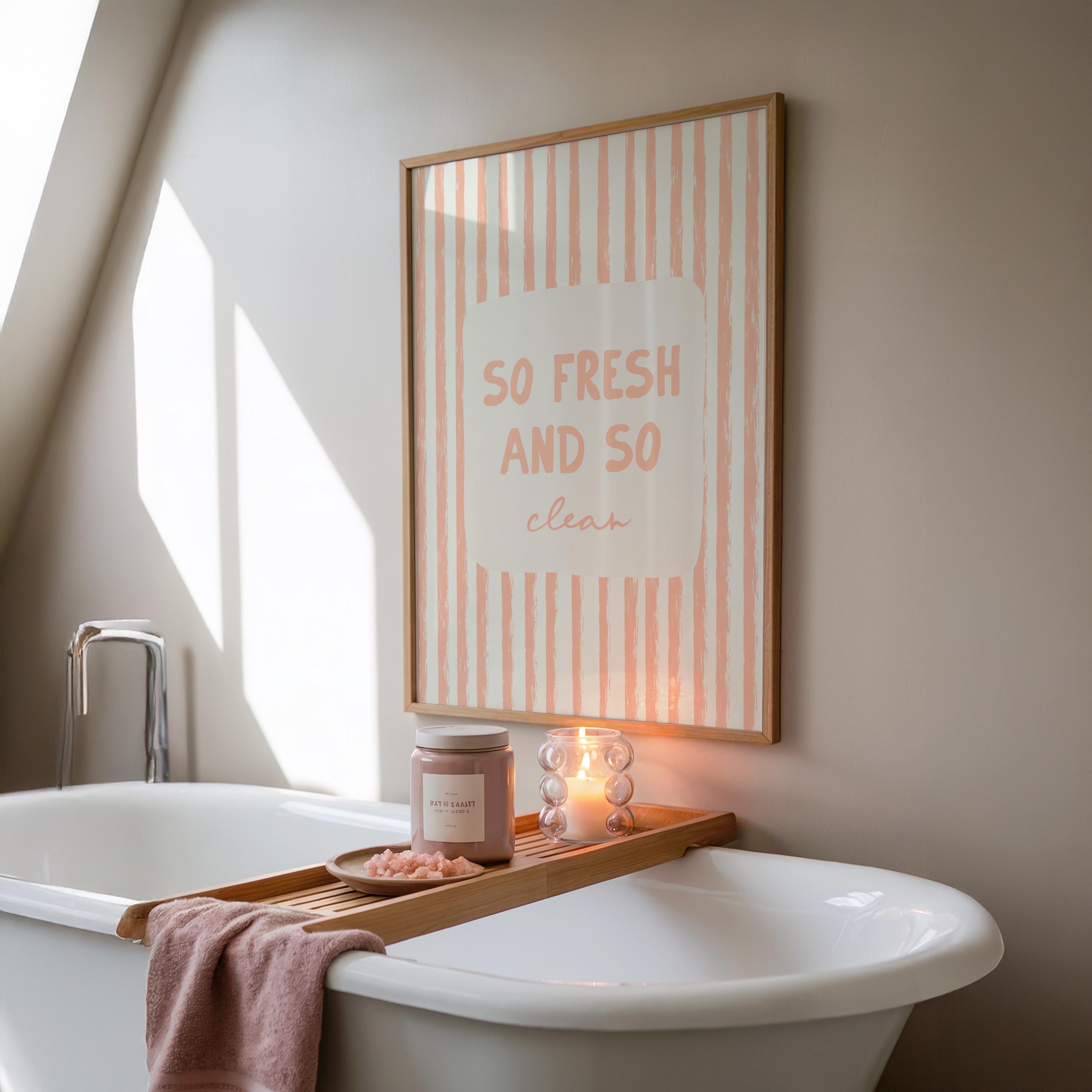 Bathroom setting with a bathtub, candles, and a framed print on the wall.