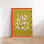 Framed poster with 'This is my happy place' text on a white wall.