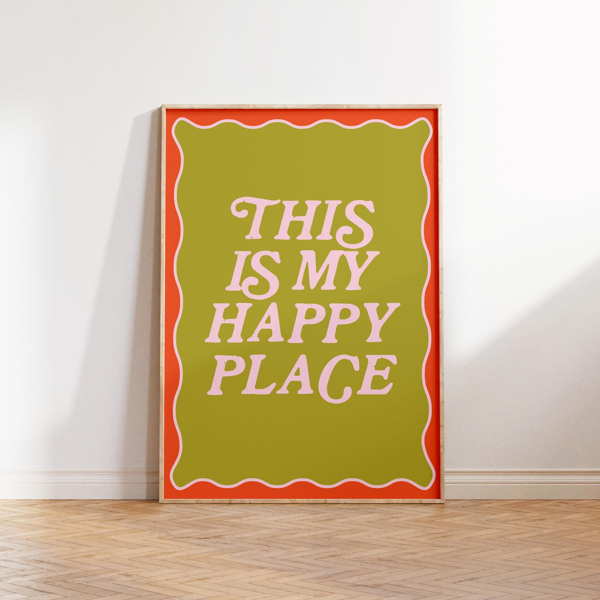 Framed poster with 'This is my happy place' text on a white wall.