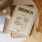 Brunch club flyer on a wooden table with a cup of coffee.