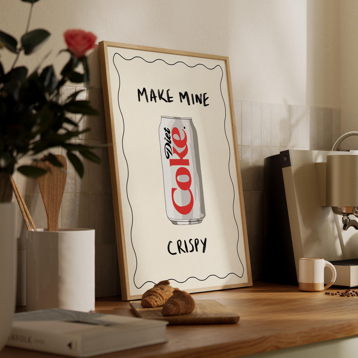 Framed poster with Diet Coke can design on a wooden shelf.