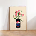 Framed artwork of a Pepsi Max can with tulips on a white wall.
