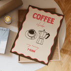 Coffee club flyer on a table with a cup of coffee and book