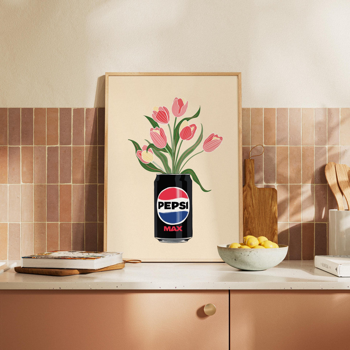 Framed artwork of a Pepsi Max can with tulips on a kitchen counter.