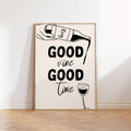 Framed artwork with 'Good wine Good time' text and wine graphics on a white wall.