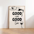 Framed artwork with 'Good wine Good time' text and wine graphics on a white wall.