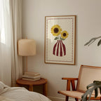 Room interior with a framed picture of sunflowers, lamp, and chair.