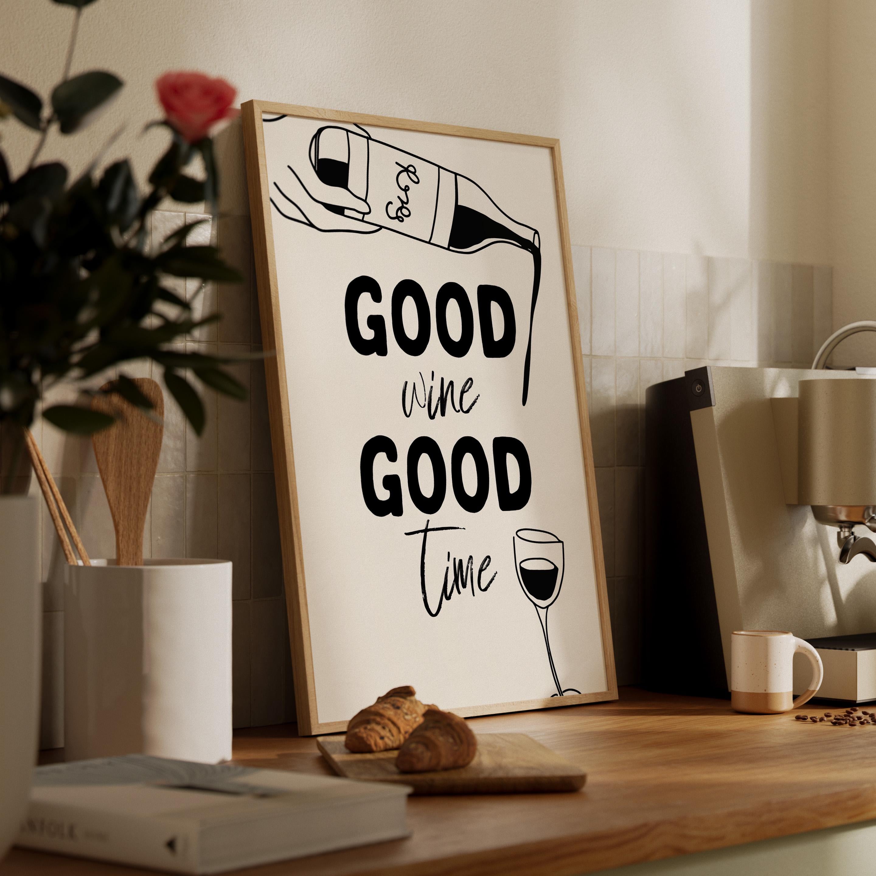 Framed poster with 'Good wine Good time' text on a wooden shelf with books and a plant.