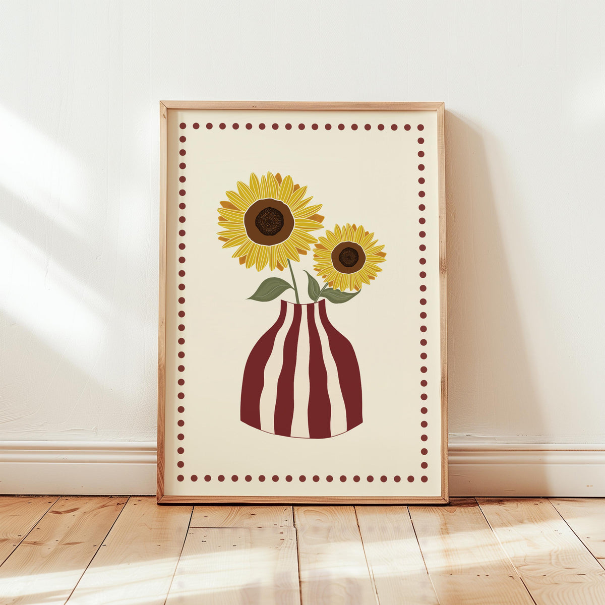 Framed artwork of sunflowers in a striped vase on a wooden floor.