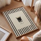 Person sitting on a wooden floor with a decorative rug featuring a coffee cup design.