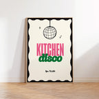 Framed poster with 'Kitchen Disco' text and disco ball design on a white wall.