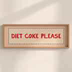 Framed sign with 'Diet Coke Please' text on a beige wall