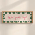 Framed artwork with 'Love you, bye' text on a beige background