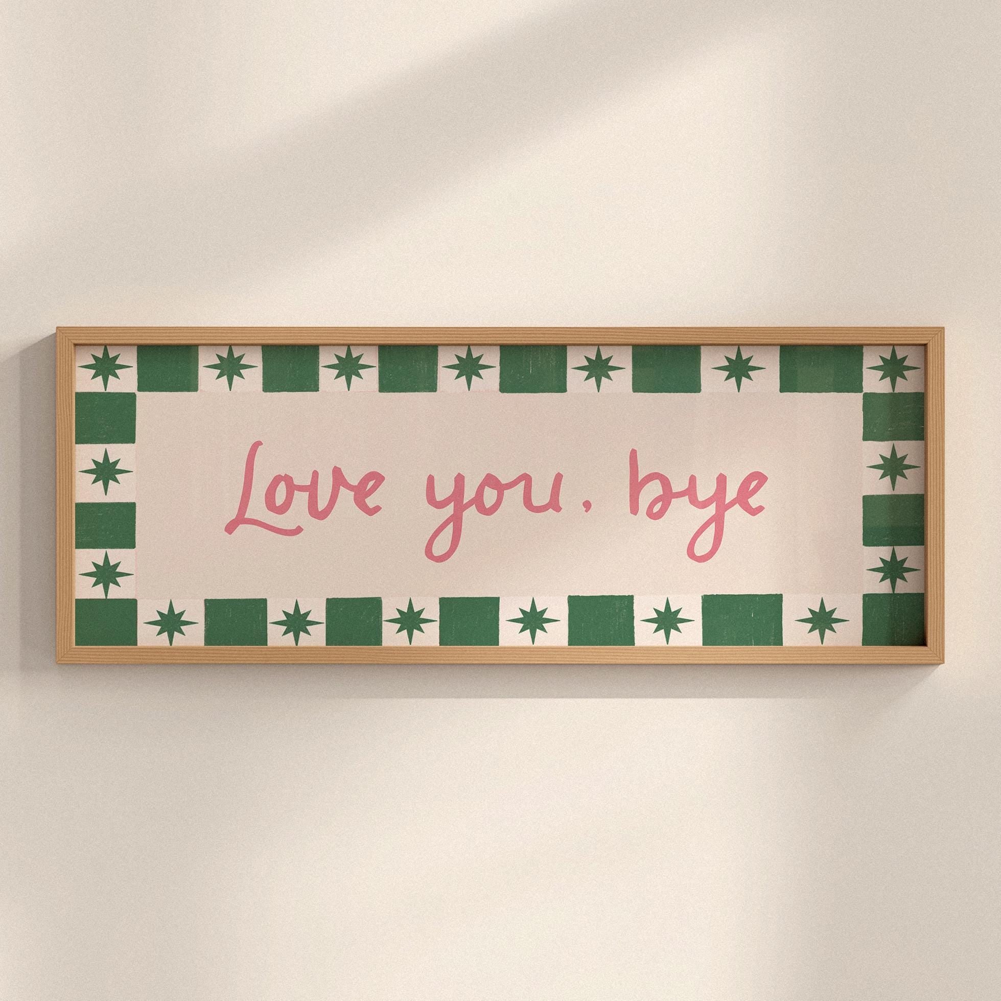 Framed artwork with 'Love you, bye' text on a beige background