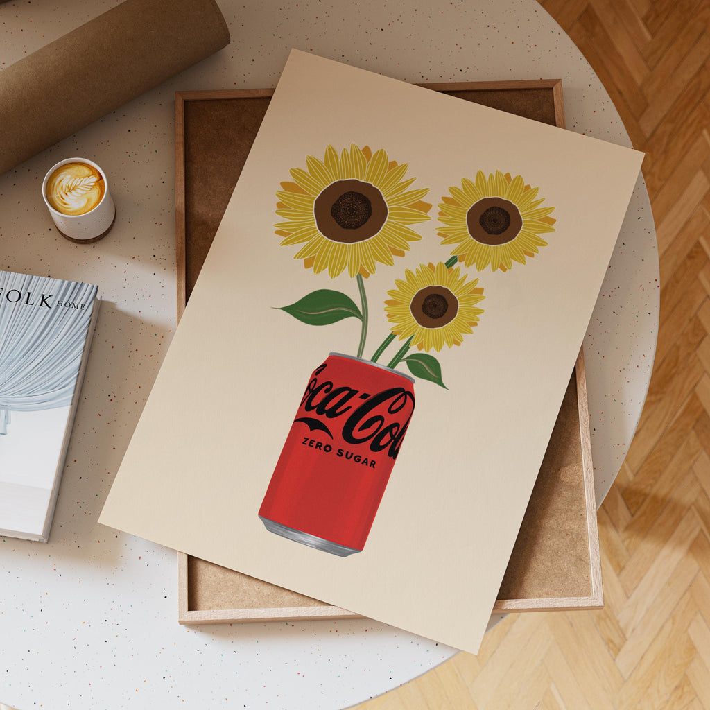 Notebook with Coca-Cola Zero Sugar design featuring sunflowers on a wooden surface.