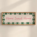 Decorative sign with 'Home Sweet Home' text on a wall