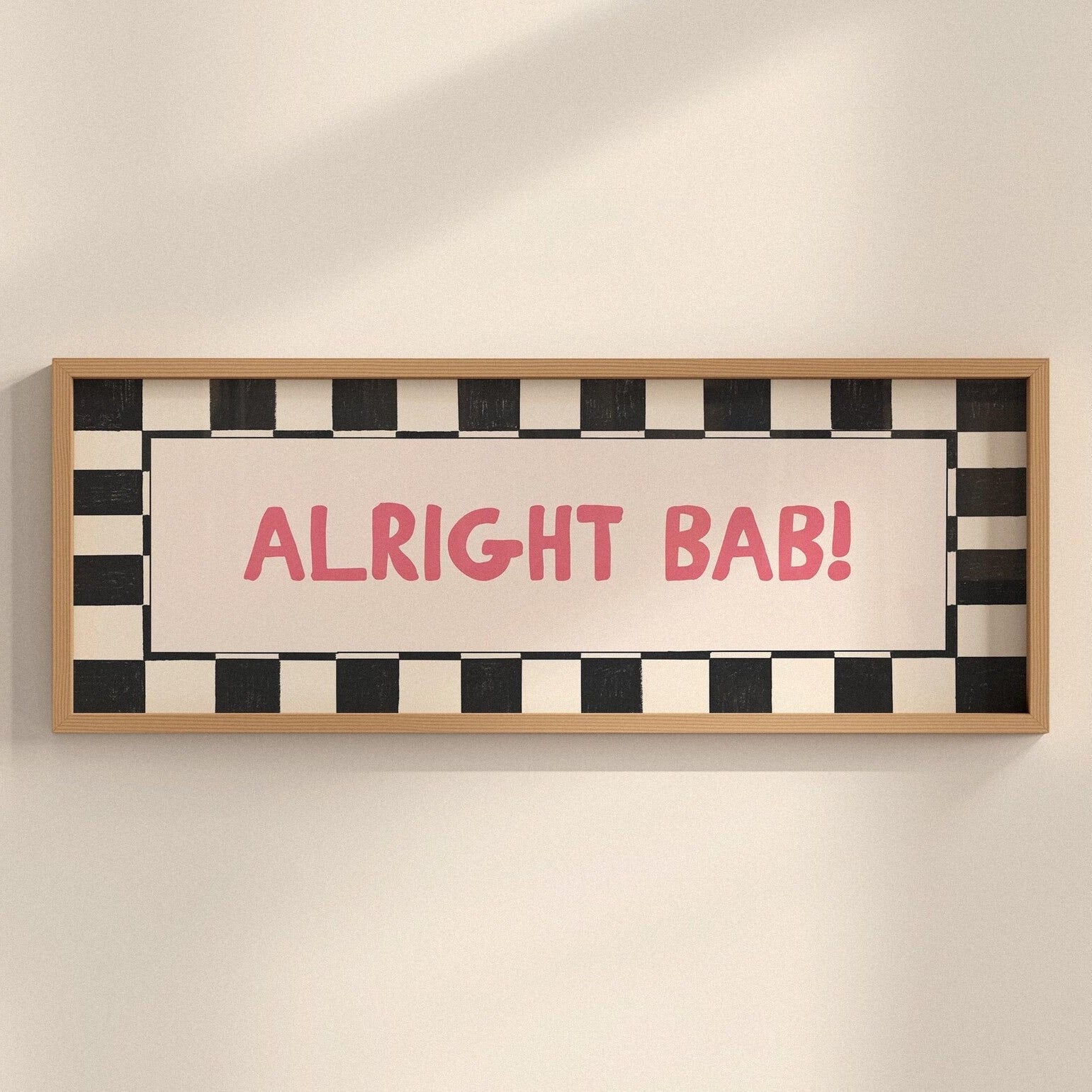 Framed sign with 'ALRIGHT BAB!' text on a checkered background