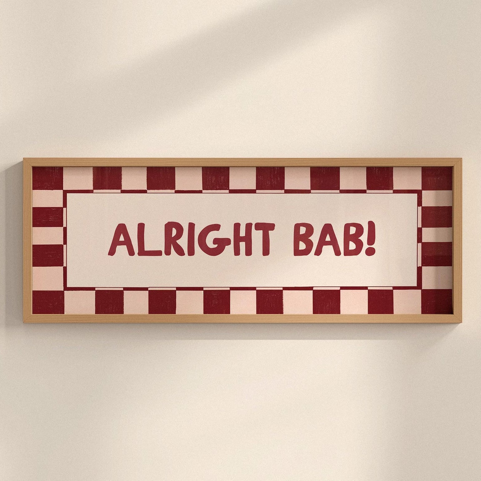 Framed sign with 'ALRIGHT BAB!' text on a checkered background