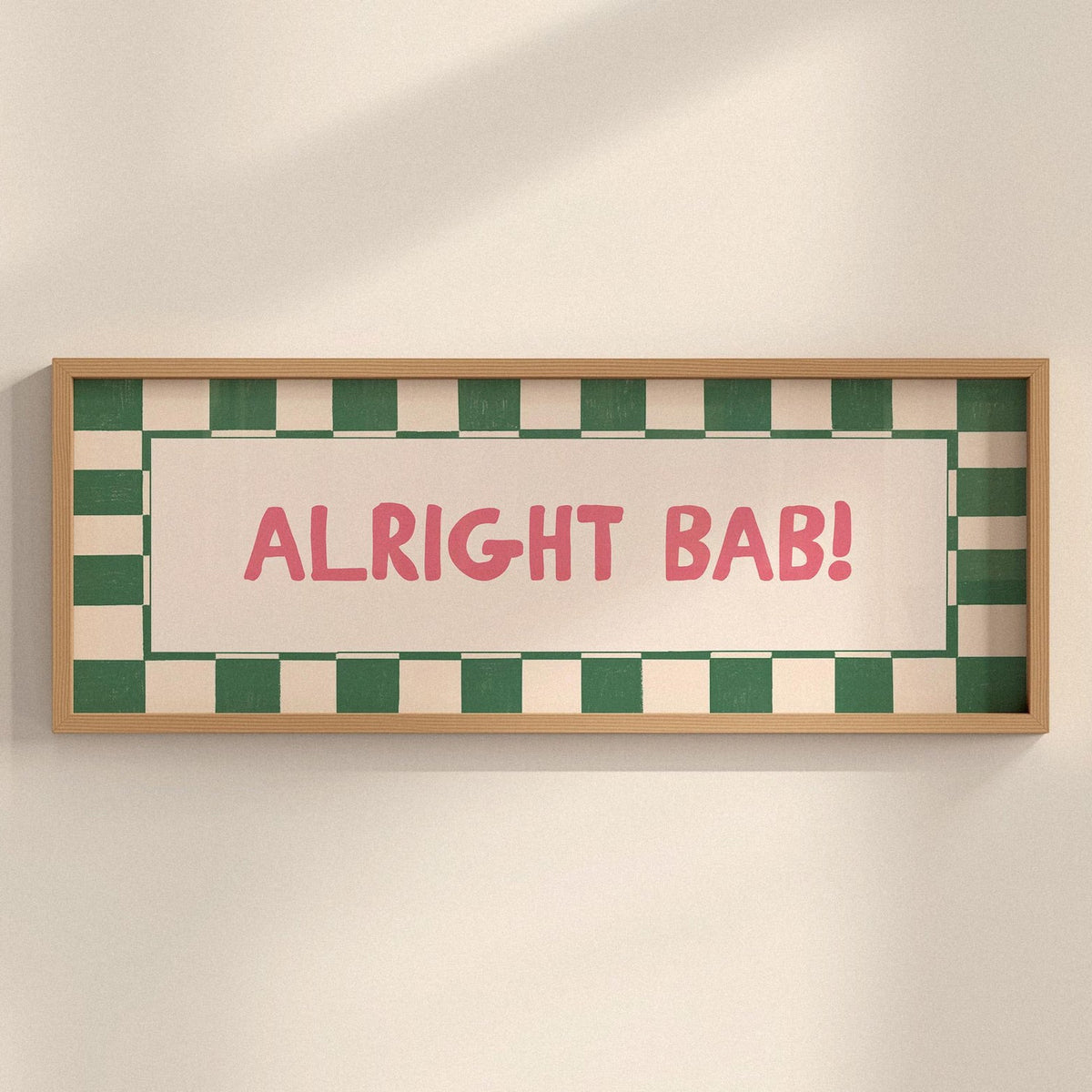 Framed sign with 'ALRIGHT BAB!' text on a checkered background