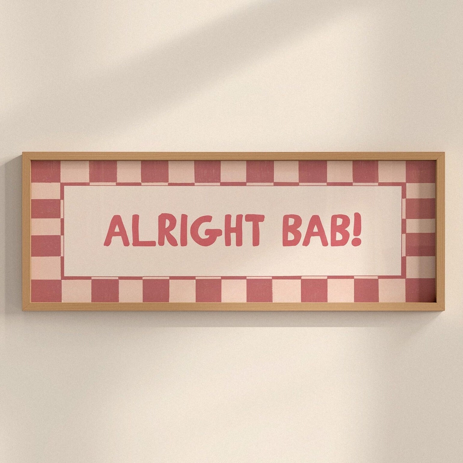 Framed sign with 'ALRIGHT BAB!' text on a checkered background