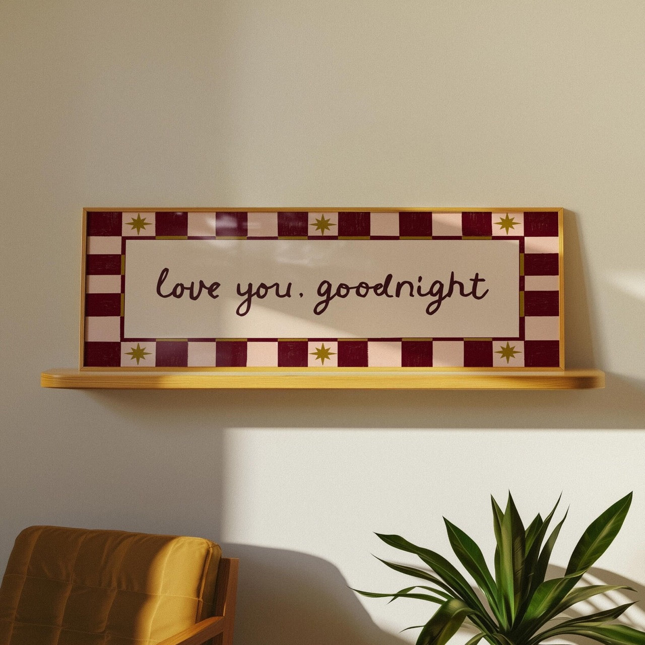 Decorative sign with 'love you, goodnight' text on a shelf against a wall.